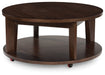 Korestone 2 - Round Cocktail Table - Dark Brown – Coffee Tables by Signature Design by Ashley® at Furniture Wholesale Plus , Nashville furniture store