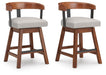 Ralene - Upholstered Swivel Barstool (Set of 2) - Medium Brown – Stool Sets by Signature Design by Ashley® at Furniture Wholesale Plus , Nashville furniture store