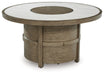 Rainier Ranch - Beige - Round Fire Pit Table - Premium Fire Pits from Signature Design by Ashley® - Just $1038! Shop now at Furniture Wholesale Plus  We are the best furniture store in Nashville, Hendersonville, Goodlettsville, Madison, Antioch, Mount Juliet, Lebanon, Gallatin, Springfield, Murfreesboro, Franklin, Brentwood