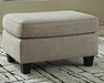 Kestrel - Ottoman - Driftwood – Upholstered Ottomans by Ashley® at Furniture Wholesale Plus , Nashville furniture store