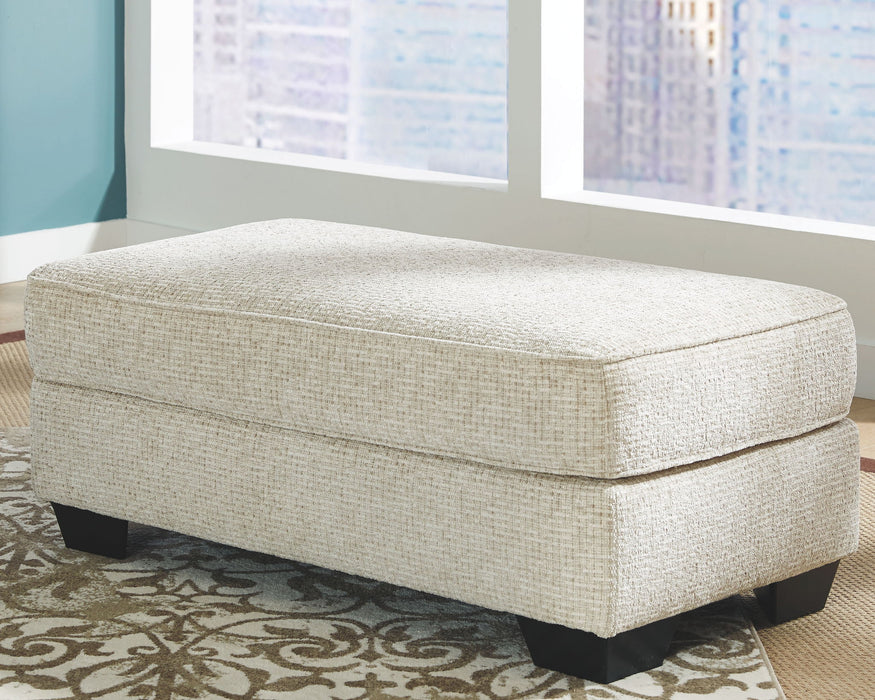 Monaghan - Ottoman - Sandstone – Upholstered Ottomans by Signature Design by Ashley® at Furniture Wholesale Plus , Nashville furniture store