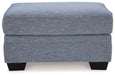 Carissa Manor - Ottoman - Denim – Upholstered Ottomans by Benchcraft® at Furniture Wholesale Plus , Nashville furniture store