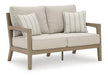 Hallow Creek Outdoor Loveseat with Cushion - Premium Outdoor Seating from Ashley Furniture - Just $1243.79! Shop now at Furniture Wholesale Plus  We are the best furniture store in Nashville, Hendersonville, Goodlettsville, Madison, Antioch, Mount Juliet, Lebanon, Gallatin, Springfield, Murfreesboro, Franklin, Brentwood