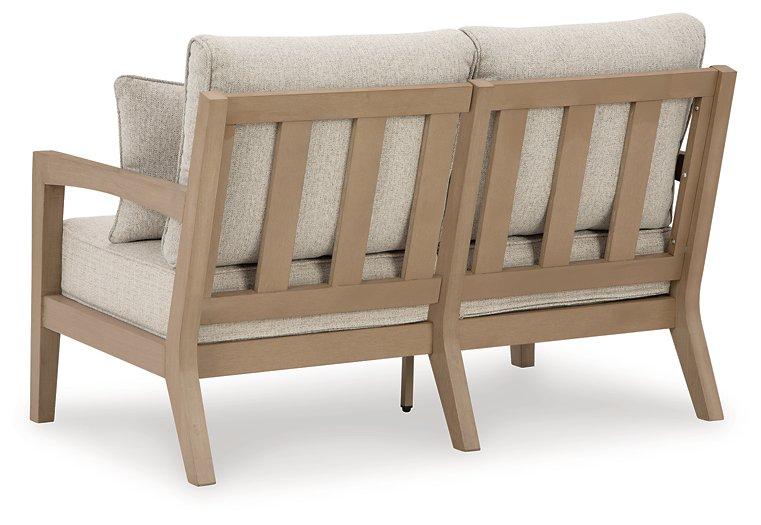 Hallow Creek Outdoor Loveseat with Cushion - Premium Outdoor Seating from Ashley Furniture - Just $1243.79! Shop now at Furniture Wholesale Plus  We are the best furniture store in Nashville, Hendersonville, Goodlettsville, Madison, Antioch, Mount Juliet, Lebanon, Gallatin, Springfield, Murfreesboro, Franklin, Brentwood