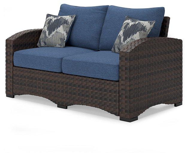 Windglow Outdoor Loveseat with Cushion - Premium Outdoor Seating from Ashley Furniture - Just $560.58! Shop now at Furniture Wholesale Plus  We are the best furniture store in Nashville, Hendersonville, Goodlettsville, Madison, Antioch, Mount Juliet, Lebanon, Gallatin, Springfield, Murfreesboro, Franklin, Brentwood