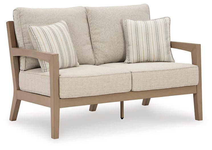 Hallow Creek Outdoor Loveseat with Cushion - Premium Outdoor Seating from Ashley Furniture - Just $1243.79! Shop now at Furniture Wholesale Plus  We are the best furniture store in Nashville, Hendersonville, Goodlettsville, Madison, Antioch, Mount Juliet, Lebanon, Gallatin, Springfield, Murfreesboro, Franklin, Brentwood