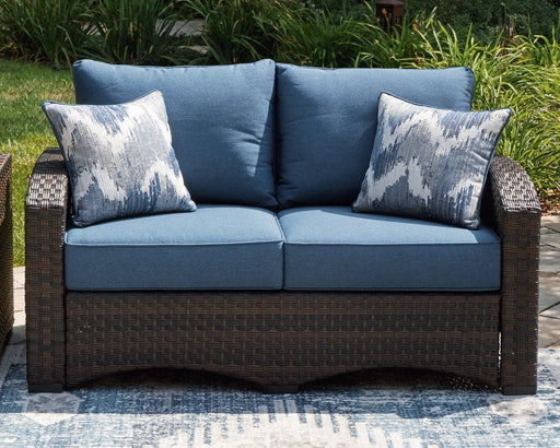 Windglow Outdoor Loveseat with Cushion - Premium Outdoor Seating from Ashley Furniture - Just $560.58! Shop now at Furniture Wholesale Plus  We are the best furniture store in Nashville, Hendersonville, Goodlettsville, Madison, Antioch, Mount Juliet, Lebanon, Gallatin, Springfield, Murfreesboro, Franklin, Brentwood