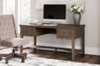 Janismore Home Office Storage Leg Desk - Premium Desk from Ashley Furniture - Just $579.20! Shop now at Furniture Wholesale Plus  We are the best furniture store in Nashville, Hendersonville, Goodlettsville, Madison, Antioch, Mount Juliet, Lebanon, Gallatin, Springfield, Murfreesboro, Franklin, Brentwood