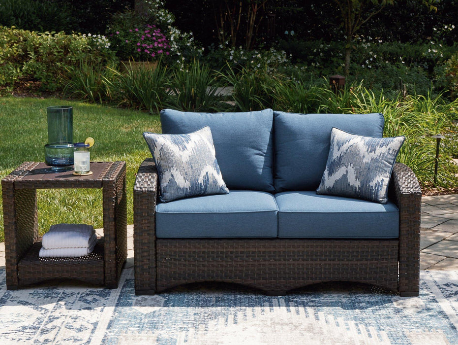 Windglow Outdoor Loveseat with Cushion - Premium Outdoor Seating from Ashley Furniture - Just $560.58! Shop now at Furniture Wholesale Plus  We are the best furniture store in Nashville, Hendersonville, Goodlettsville, Madison, Antioch, Mount Juliet, Lebanon, Gallatin, Springfield, Murfreesboro, Franklin, Brentwood