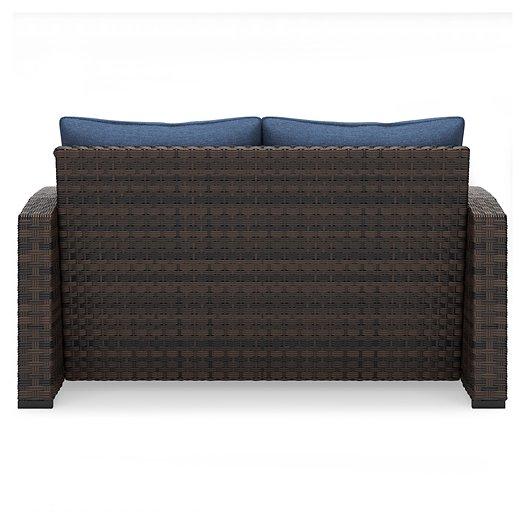 Windglow Outdoor Loveseat with Cushion - Premium Outdoor Seating from Ashley Furniture - Just $560.58! Shop now at Furniture Wholesale Plus  We are the best furniture store in Nashville, Hendersonville, Goodlettsville, Madison, Antioch, Mount Juliet, Lebanon, Gallatin, Springfield, Murfreesboro, Franklin, Brentwood