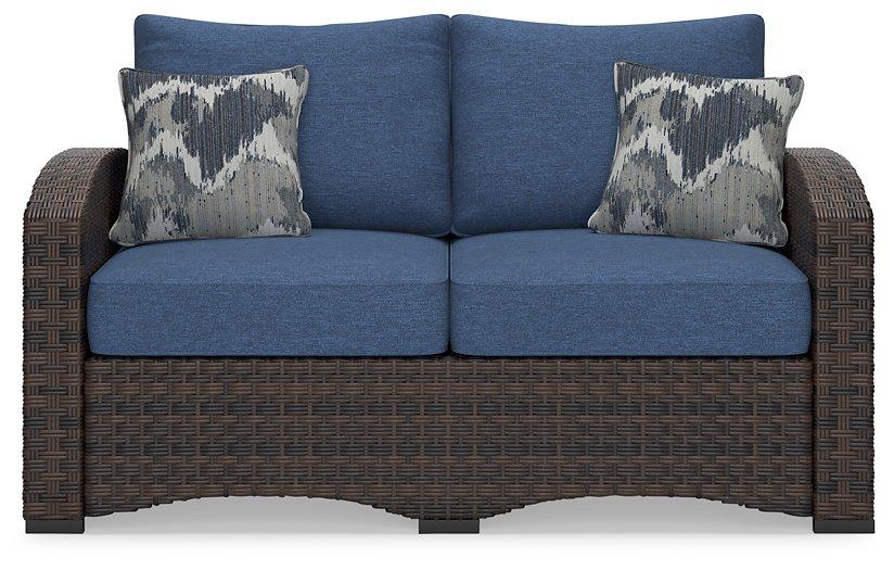 Windglow Outdoor Loveseat with Cushion - Premium Outdoor Seating from Ashley Furniture - Just $560.58! Shop now at Furniture Wholesale Plus  We are the best furniture store in Nashville, Hendersonville, Goodlettsville, Madison, Antioch, Mount Juliet, Lebanon, Gallatin, Springfield, Murfreesboro, Franklin, Brentwood