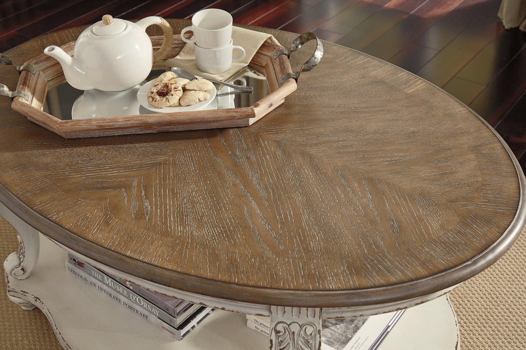 Realyn Coffee Table - Premium Cocktail Table from Ashley Furniture - Just $333.88! Shop now at Furniture Wholesale Plus  We are the best furniture store in Nashville, Hendersonville, Goodlettsville, Madison, Antioch, Mount Juliet, Lebanon, Gallatin, Springfield, Murfreesboro, Franklin, Brentwood