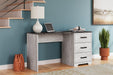 Shawburn 54" Home Office Desk - Premium Desk from Ashley Furniture - Just $176.01! Shop now at Furniture Wholesale Plus  We are the best furniture store in Nashville, Hendersonville, Goodlettsville, Madison, Antioch, Mount Juliet, Lebanon, Gallatin, Springfield, Murfreesboro, Franklin, Brentwood