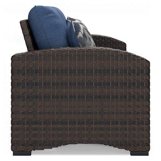 Windglow Outdoor Loveseat with Cushion - Premium Outdoor Seating from Ashley Furniture - Just $560.58! Shop now at Furniture Wholesale Plus  We are the best furniture store in Nashville, Hendersonville, Goodlettsville, Madison, Antioch, Mount Juliet, Lebanon, Gallatin, Springfield, Murfreesboro, Franklin, Brentwood