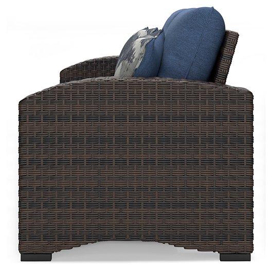 Windglow Outdoor Loveseat with Cushion - Premium Outdoor Seating from Ashley Furniture - Just $560.58! Shop now at Furniture Wholesale Plus  We are the best furniture store in Nashville, Hendersonville, Goodlettsville, Madison, Antioch, Mount Juliet, Lebanon, Gallatin, Springfield, Murfreesboro, Franklin, Brentwood