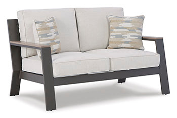 Tropicava Outdoor Loveseat with Cushion - Premium Outdoor Seating from Ashley Furniture - Just $678.86! Shop now at Furniture Wholesale Plus  We are the best furniture store in Nashville, Hendersonville, Goodlettsville, Madison, Antioch, Mount Juliet, Lebanon, Gallatin, Springfield, Murfreesboro, Franklin, Brentwood