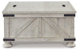 Carynhurst Coffee Table - Premium Cocktail Table from Ashley Furniture - Just $360.36! Shop now at Furniture Wholesale Plus  We are the best furniture store in Nashville, Hendersonville, Goodlettsville, Madison, Antioch, Mount Juliet, Lebanon, Gallatin, Springfield, Murfreesboro, Franklin, Brentwood