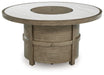 Rainier Ranch - Beige - Round Fire Pit Table - Premium Fire Pits from Signature Design by Ashley® - Just $1038! Shop now at Furniture Wholesale Plus  We are the best furniture store in Nashville, Hendersonville, Goodlettsville, Madison, Antioch, Mount Juliet, Lebanon, Gallatin, Springfield, Murfreesboro, Franklin, Brentwood